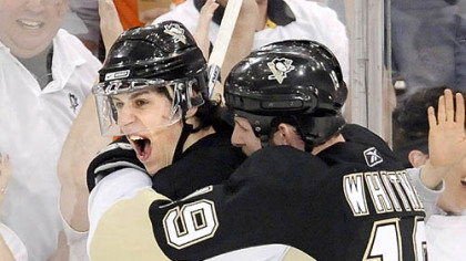Ryan Whitney congratulates Evgeni Malkin after Malkin's second-period goal against the Flyers May 9.