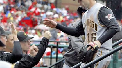 Third baseman Doug Mientkiewicz is congratulated by teammates after making a diving catch against the Cardinals in the second inning yesterday in St. Louis.