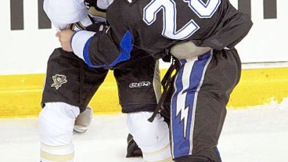 The Lightning's Zenon Konopka (28) fights Penguins defenseman Danny Richmond last night in preseason action in Tampa, Fla. The Penguins won, 3-2.