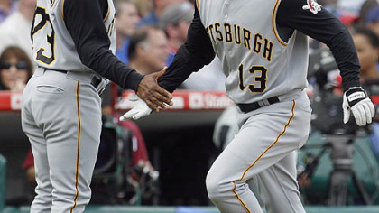 Nate McLouth, right, celebrates with third base coach Tony Beasley after hitting a solo home run against the Chicago Cubs during the seventh inning of yesterday's baseball game in Chicago.