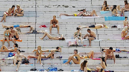 BELGRADE -- People cool off poolside as temperatures climbed throughout the country.