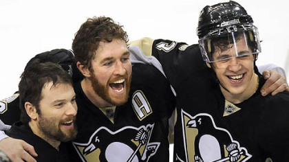 Penguins Petr Sykora, Ryan Malone and Evgeni Malkin celebrate their win against the Flyers Sunday.