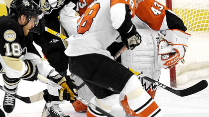 Penguins Marian Hossa reaches in to score on Flyers goalie Martin Biron in the second period.