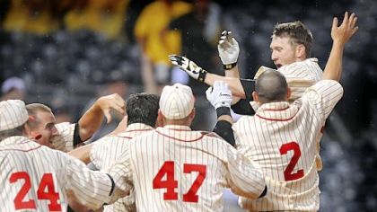 Jason Bay jumps on home plate and is mobbed by teammates after his solo home run in the 13th inning gave the Pirates a 4-3 win against Tampa Bay last night at PNC Park.