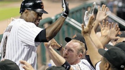 Miguel Tejada's grand slam in the sixth inning broke the game open for Houston, which clings to the hope of catching Milwaukee for the wild card.