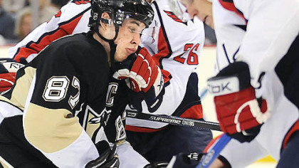 Sidney Crosby takes a shot from the Capitals Shaone Morrison ;ast night at Mellon Arena.