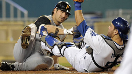 Dodgers catcher Russell Martin holds up his glove after tagging out the Pirates' Xavier Nady at home plate during second the inning of their baseball game last night.