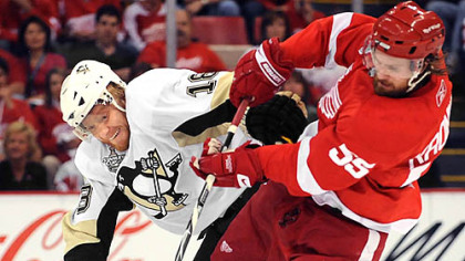 Penguins' Marian Hossa battles with Red Wings' Niklas Kronwall.