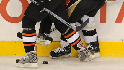 Crosby collides with linesman Brad Lazarowich.