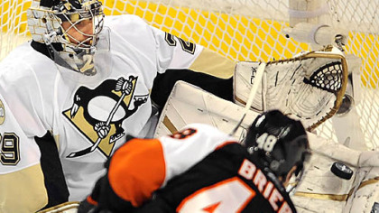 Penguins goalie Marc-Andre Fleury makes a save on Flyers Danny Briere.