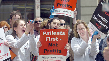 Sarah Ramer, left, a University of Pittsburgh medical student, Dr. Ron Codario, a resident at UPMC, and Dr. Miranda Gillespie, also a UPMC resident, cheer during yesterday's "Hands off Our Health Care!" rally outside Fifth Avenue Place, Downtown, where Highmark has its headquarters.