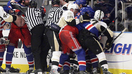 New York Rangers' Paul Mara, left, is held back by linesman Jean Morin during a scuffle with the Penguins' Evgeni Malkin after Rangers' Jaromir Jagr scored with 14 seconds left in the third period during Game 4 of an NHL Eastern Conference semifinal hockey playoff series Thursday, in New York. The Rangers won 3-0.