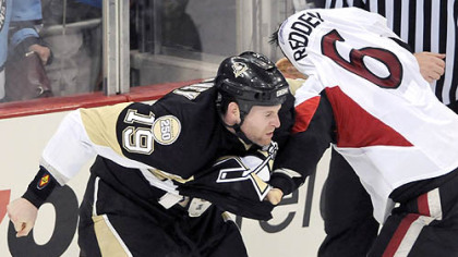 Ryan Whitney fights the Senators' Wade Redden in the third period last night.