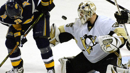 Penguins goalie Ty Conklin, right, makes a save as he is screened by Buffalo Sabres center Thomas Vanek, of Austria, during the third period of the game last night in Buffalo, N.Y.