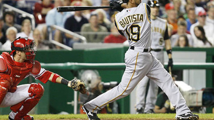 The Pirates' Jose Bautista follows through with a home run in the third inning of an baseball game against the Washington Nationals, yesterday in Washington. At left is Washington Nationals catcher Wil Nieves.
