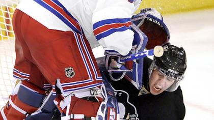Evgeni Malkin gets caught up under Rangers goalie Henrik Lundqvist late in deciding game Sunday at Mellon Arena.