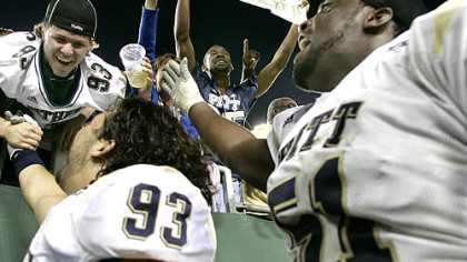 Pitt's Gus Mustakas (93) and Tommie Duhart (51) celebrate their 26-21 upset over South Florida  with fans in Tampa, Fla.