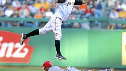 Luis Rivas attempts to catch a throw from catcher Ryan Doumit as the Reds' Chris Dickerson steals second base in the first inning last night at PNC Park.