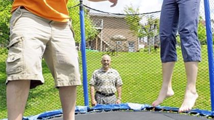 Post-Gazette
Barb Wallace takes a turn on the backyard trampoline with her autistic son, Matty, 15, as her husband, Mark, watches.