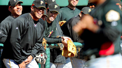 Pirate Kevin Thompson poses for Topps Baseball Cards as his teammates get a good laugh from his photo shoot.