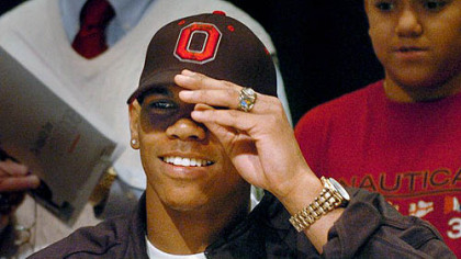 Terrelle Pryor puts on an Ohio State hat to announce his college choice March 19.