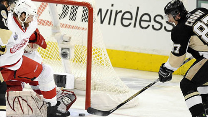 Sidney Crosby gets his second  goal of the night against the Red Wings' Chris Osgood in the second period.