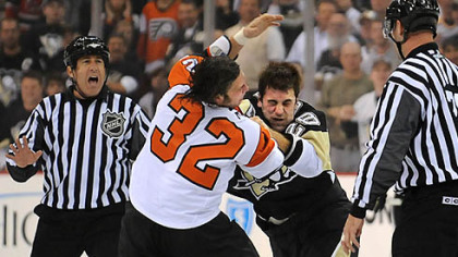 Eric Godard, right, and Philadelphia's Riley Cote squared off early in last night's game at Mellon Arena. Apparently, they aren't listening to the official.