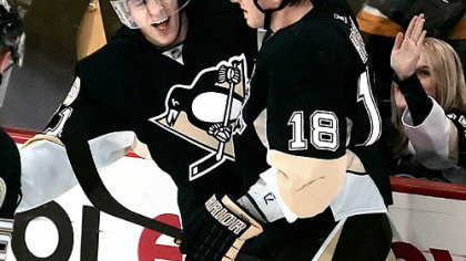 Team MVP Evgeni Malkin, left, celebrates his second-period goal with Marian Hossa.