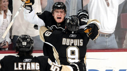 Marian Hossa is congratulated by teammates Pascal Dupuis and Kris Letang after scoring the winning goal in overtime to beat the Rangers Sunday afternoon.