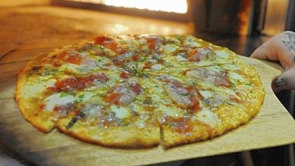 The secret to the pizza from Six Penn Kitchen in Downtown Pittsburgh is the honey in the dough and a bit in the sauce.