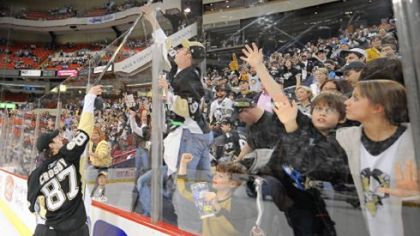 Sidney Crosby gives away his stick to a fan after the Penguins' 4-2 victory over Philadelphia at Mellon Arena last night. The equipment giveaway is a fan-appreciation tradition after the last home game of the season.