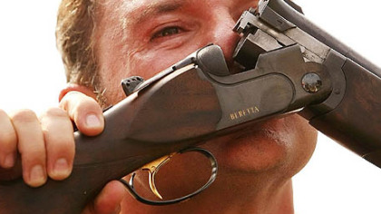 Italian Francesco D'Aniello kisses his gun after wining the silver medal in the men's double trap.