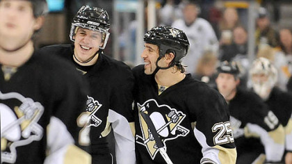 Penguins Evgeni Malkin (left) smiles with teammate Maxime Talbot after scoring his third goal against the Rangers in the third period at the Mellon Arena last night.
