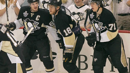 Sidney Crosby, left, and Evgeni Malkin, right, congratulate teammate Marian Hossa after Hossa scored a goal Saturday night. Coach Michel Therrien is not pleased with broadcasters criticizing the ice time of Crosby and Malkin.
