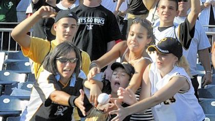 Fans bobble a ball thrown out by Pirates pitcher Ian Snell after their last game of the 2008 season.  The fans couldn''t hang onto the ball and it fell into the dugout.