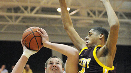 Serra Catholic's Pat Grubbs, left, looks to get a shot up against Kennedy Catholic's Aundra Jones in the first half of their Class A semifinal last night at Ambridge.