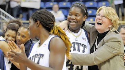 Pitt coach Agnus Berenato hugs Mercedes Walker after defeating West Virginia in overtime Feb. 26. Berenato signed a new contract yesterday to stay with the Panthers through the 2015-16 season.