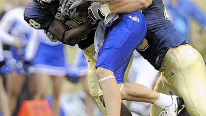 Pitt's Greg Williams, left, and Scott McKillop take down Buffalo's Brett Hamlin Sept. 6.