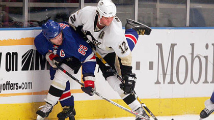 Ryan Malone battles New York's Jaromir Jagr for the puck last night at Madison Square Garden.