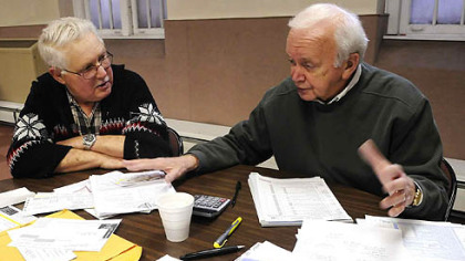 Post-Gazette
Seven-year VITA volunteer Church Johnston, right, helps Bill Moyer, of Moon, itemize his medical deductions on his 2007 federal income tax form on Monday.