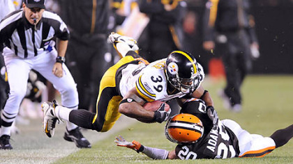 Steelers running back Willie Parker is tackled by the Browns' Mike Adams last night.