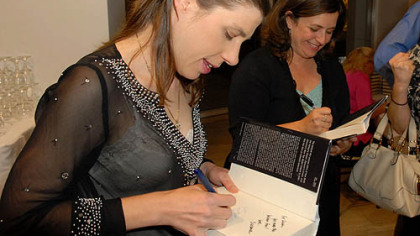 Authors Cynthia Littleton, left, and Susanne Daniels, right, sign copies of "Season Finale" at a reception launching the book late last year in Beverly Hills, Calif.