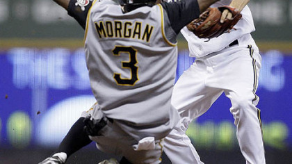Nyjer Morgan  breaks up a double play as he slides into Brewers shortstop J.J. Hardy during the seventh inning of yesterday's game in Milwaukee. The Pirates' Freddy Sanchez was safe at first.