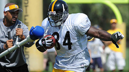 Steelers running back Rashard Mendenhall goes through a punching drill in training camp.