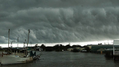HACKBERRY, La. -- A Louisiana National Guard helicopter crew attempts to make rescues as a storm front is seen on the horizon, Sunday.