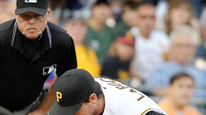 Third baseman Andy LaRoche bobbles a ball hit by Derrek Lee last night at PNC Park. LaRoche recovered in time to get the out, but the Central-leading Chicago Cubs clubbed the Pirates, 12-3.