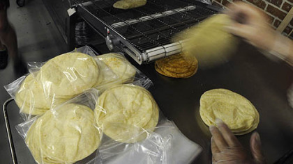 Freshly made flour tortillas are packaged at Reyna Foods on Penn Avenue in the Strip District.