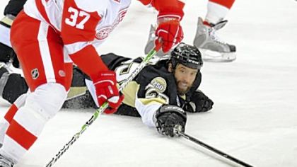 Maxime Talbot goes to the ice to try and take the puck from Detroit's Mikael Samuelsson.