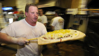 Former Mineo's Pizza House employee Regis Dusch, is back helping cook up pies during the 50th Anniversary event at the Squirrel Hill insitutution.