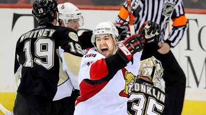 Ottawa's Andrej Meszaros celebrates the Senators' overtime win  Saturday afternoon.